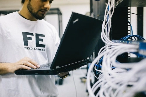 network-engineer-configuring-with-laptop